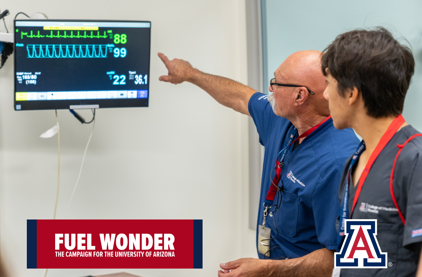 A faculty member goes over a heart monitor with a student
