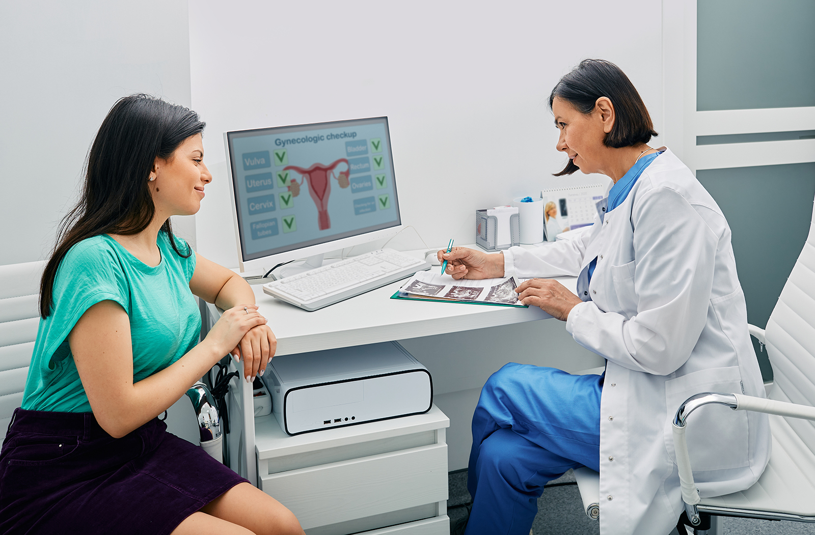 A woman consults with her OB/GYN in the doctor's office