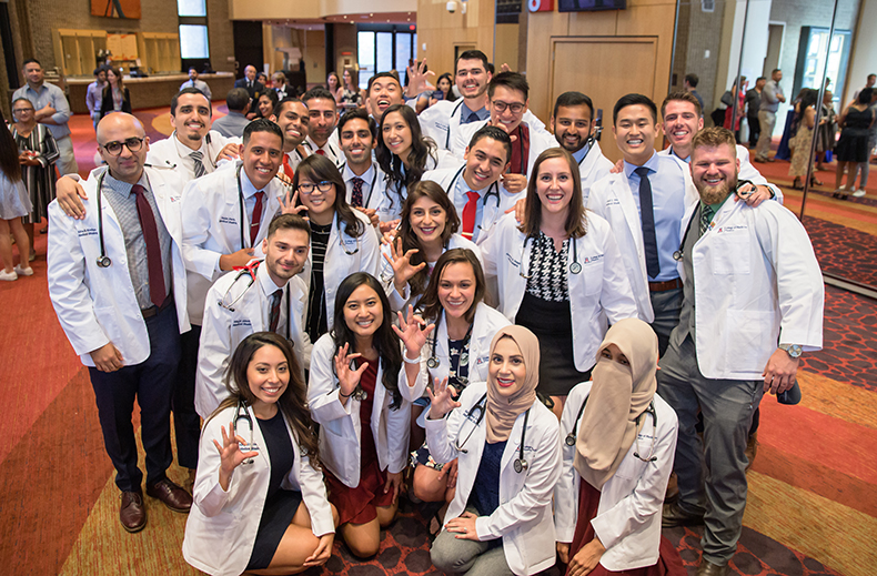 Medical Students from the Class of 2023 Pose for a Group Picture in the Lobby of Symphony Hall