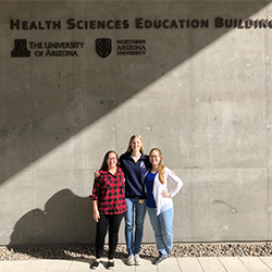 Archuleta and fellow medical students in front of the Health Sciences Education Building