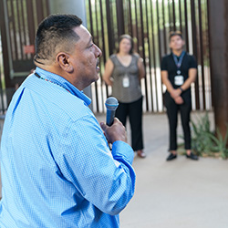 Miguel Flores, Jr., a Native American traditional healer and spiritual leader, speaks prior to the ceremony