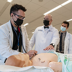 Dr. Lindgren Working with Medical Students on a Simulation Mannequin