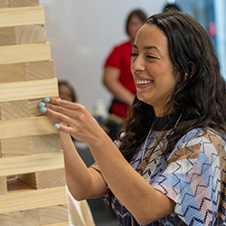 An incoming Pathway Scholars student plays Jenga during Accepted Students Day