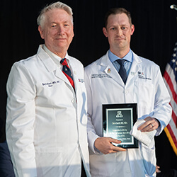 Chris Goettl, MD, MBA, with Dean Guy Reed