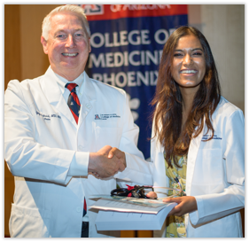 Dean Reed Shakes Hands with a Medical Student