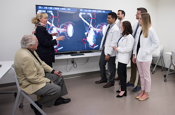 Dr. Conway with Medical Students Demonstrating the 3D Eye Trainer in the Sim Center