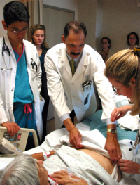 Physician and student at patient bedside