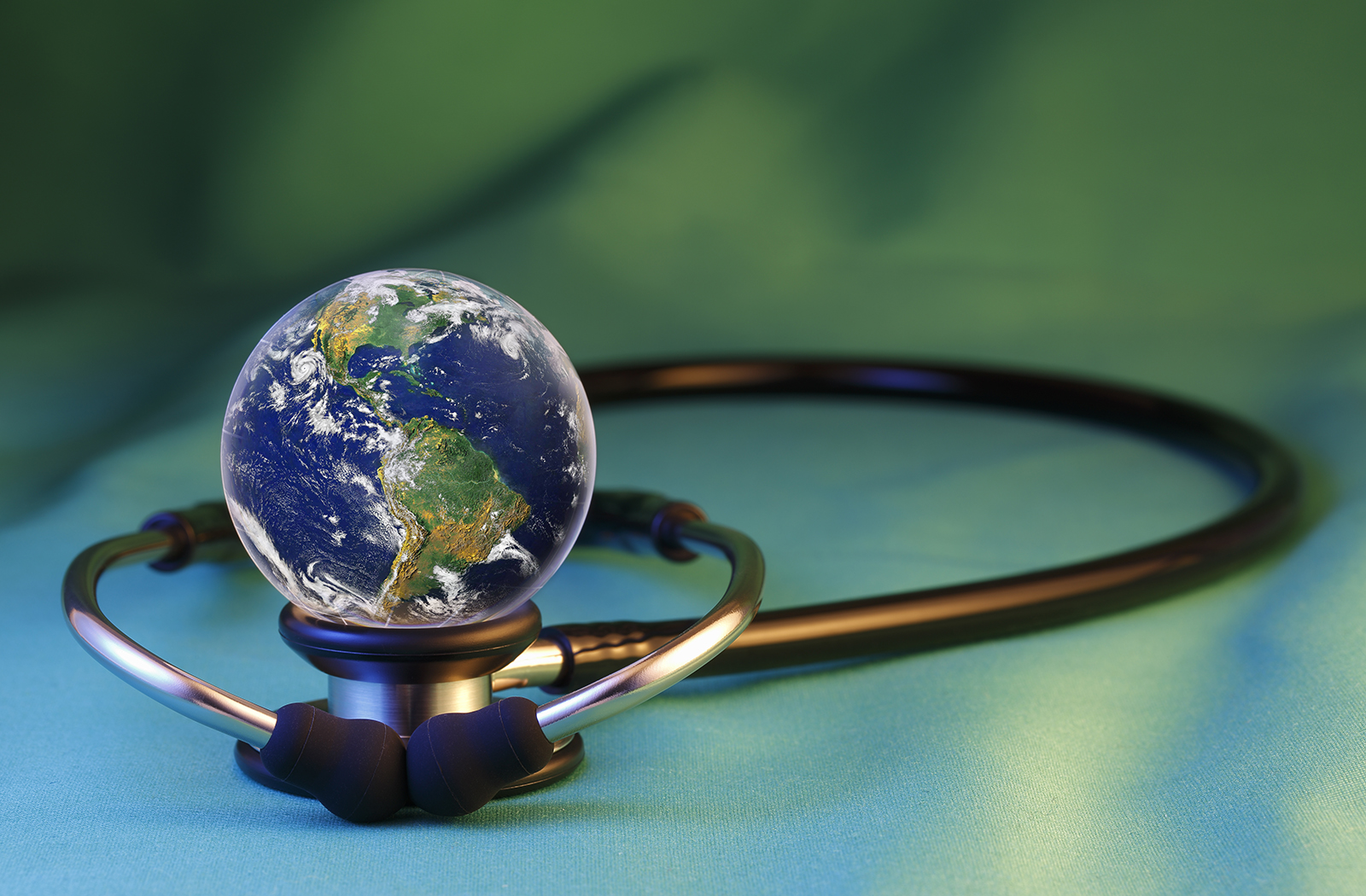A stethoscope with a small globe sitting atop it