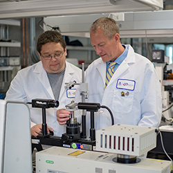 Dr. Zenhausern Works with Matthew Barrett in Their Lab
