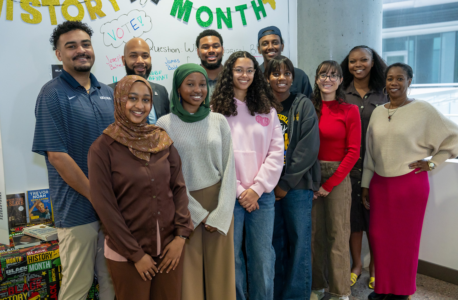 Medical students in the college's SNMA chapter, faculty and staff gather at the Black History Month display in the HSEB.