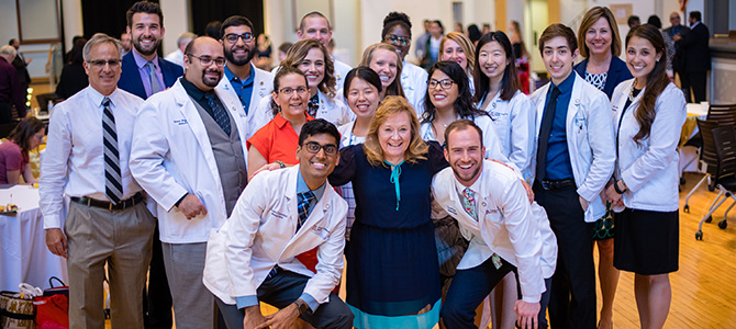 gold humanism society inductees pose for a group photo with faculty