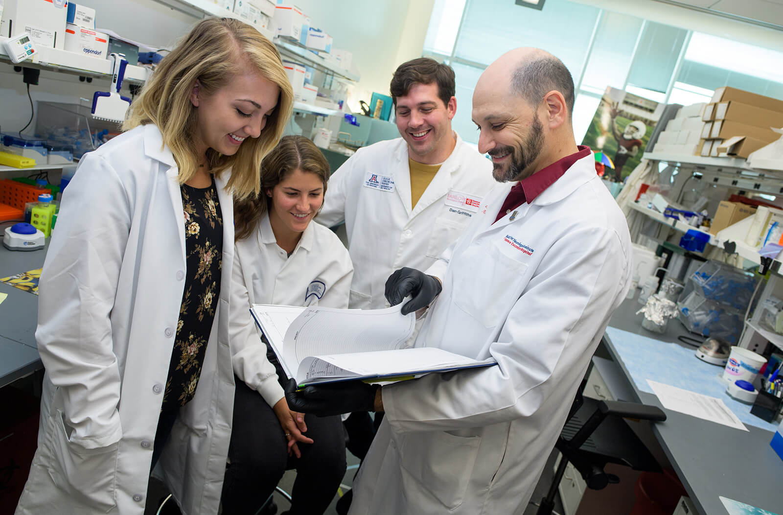 Katherine Giordano (Far Left) in the Lab with Dr. Jonathan Lifshitz (Far Right) and Others