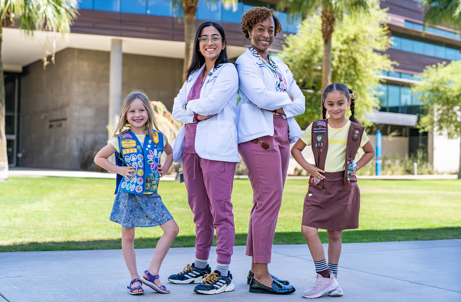 Naria Quazi and Shannon Alsobrooks, Class of 2025 medical students and former Girl Scouts, pose with attendees of the Go Girl Scouts Go STEAM Camp