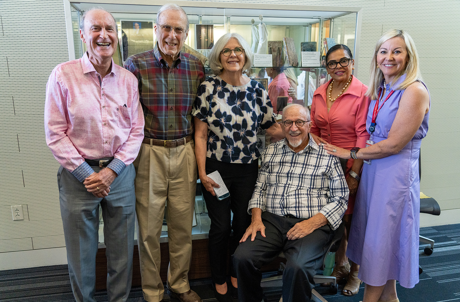 Harold Kaplan, MD, Robert E. Kravetz, MD, Mary Kaplan, Allen M. Kaplan, MD, Ranita Sharma, MD, and Julie Bowe pose together in front of the display. Harold Kaplan, MD, Robert E. Kravetz, MD, Mary Kaplan, Allen M. Kaplan, MD, Ranita Sharma, MD, and Julie Bowe pose together in front of the display.