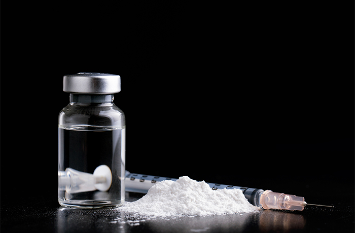 Drugs on a table -- a vial, powder and a syringe