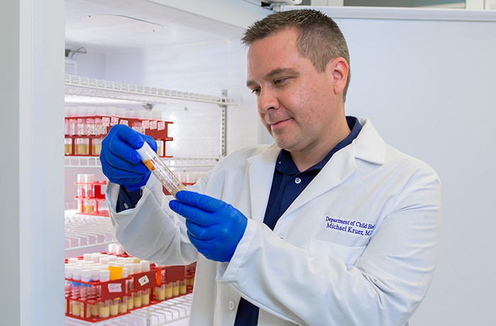 Michael Kruer, MD, Assesses a Sample in His Lab