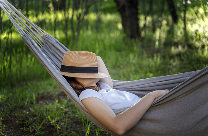 A woman takes a nap in a hammock