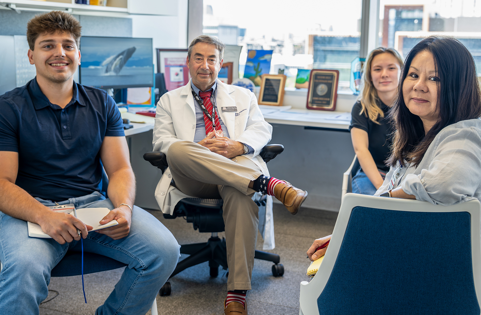 Alexander Niculescu, MD, PhD — sitting with members of his C4p team — was published in Molecular Psychiatry.