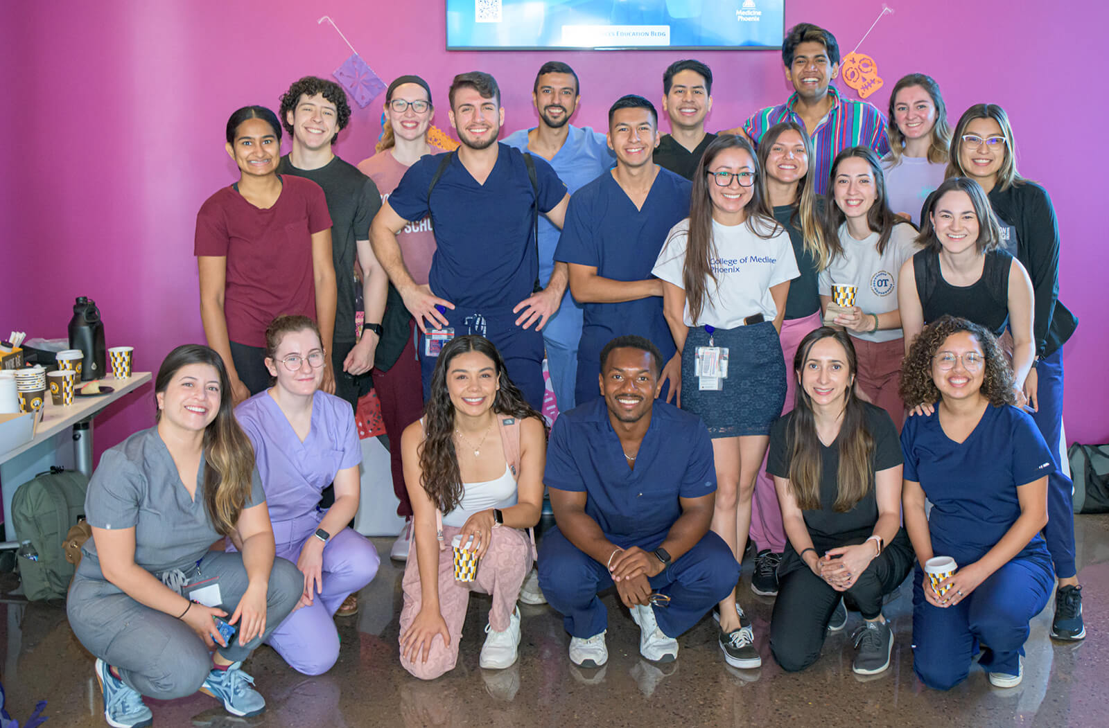 Medical students pose for a picture in front of the Día de los Muertos ofrenda