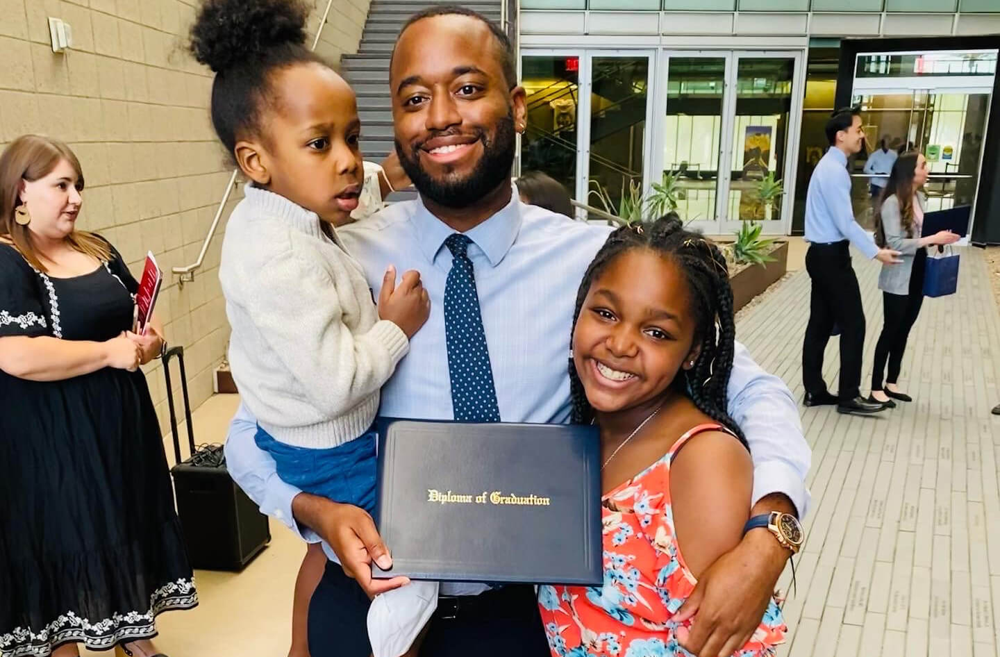 Patrick Quarles with his children at the Pathway Scholars Program graduation