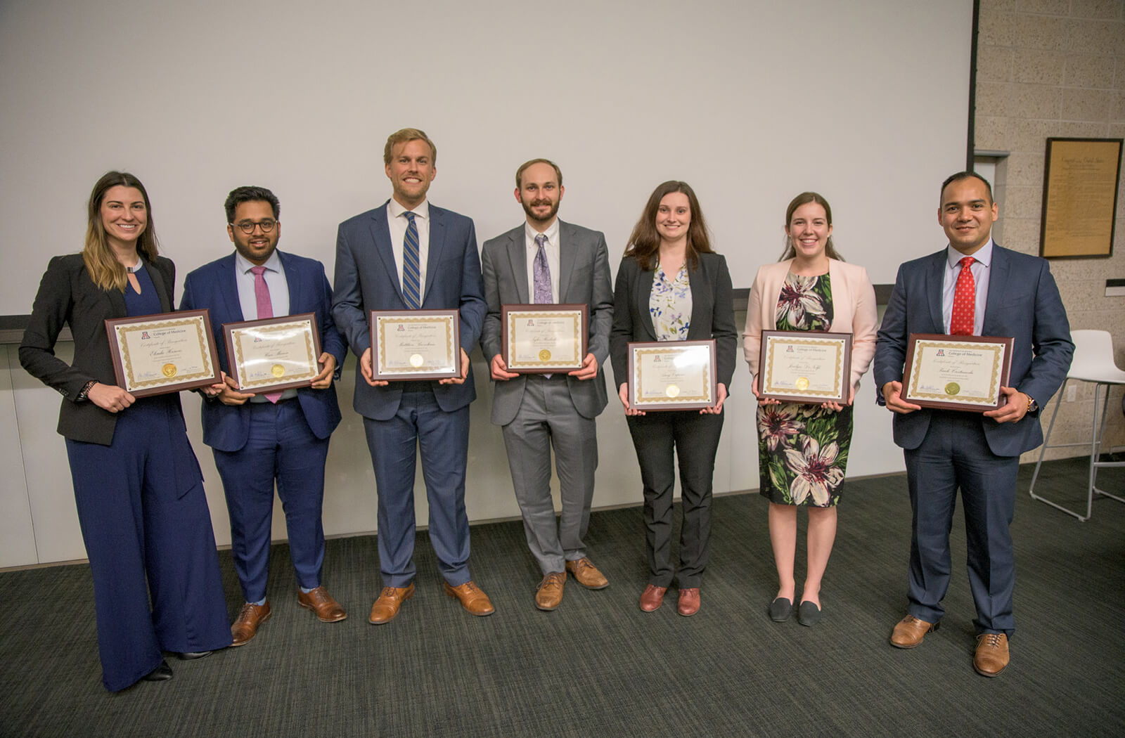 Medical Students Hold Up Their Awards at the Annual Student Research Symposium