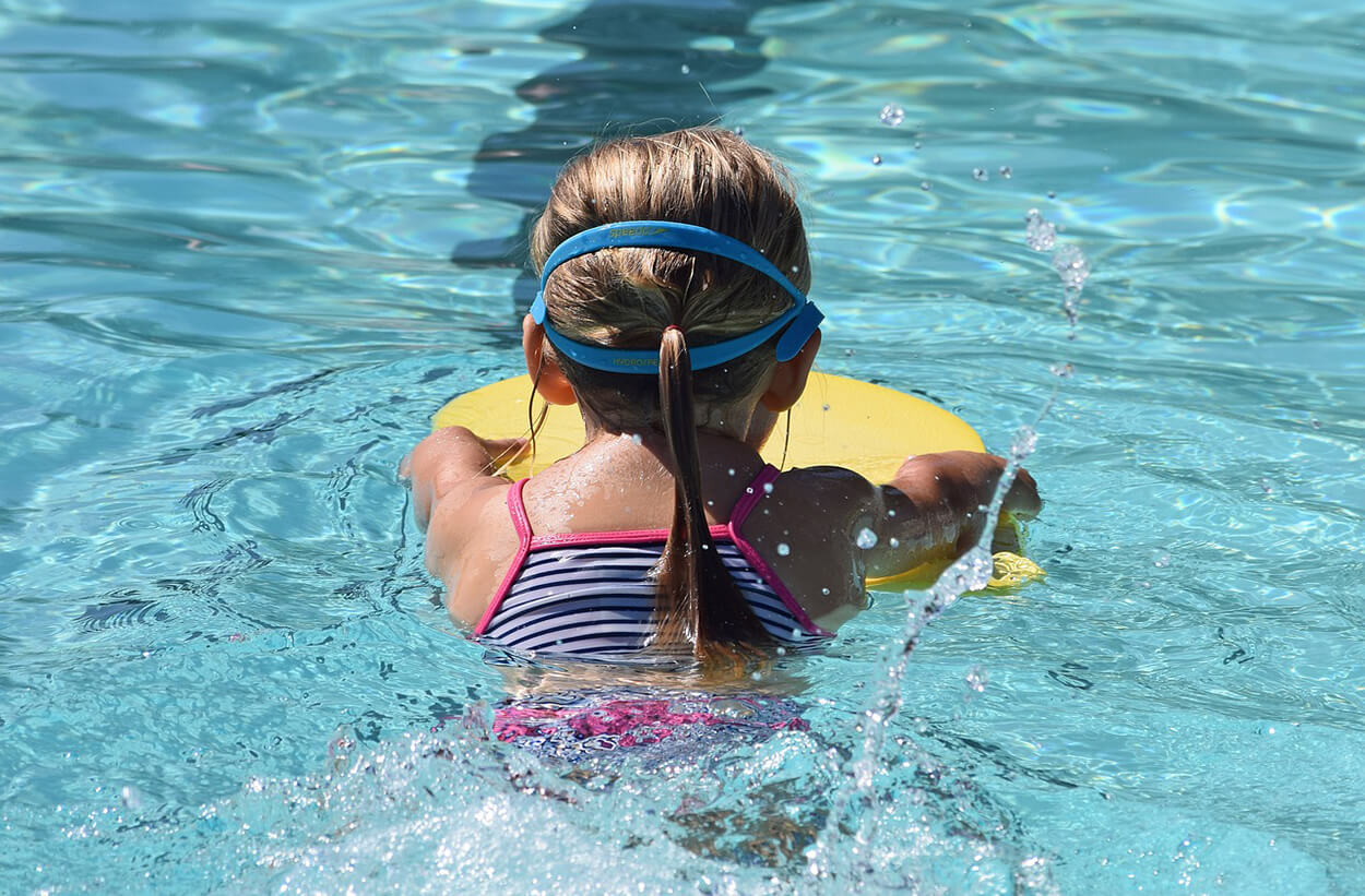 A Child Swims in a Swimming Pool