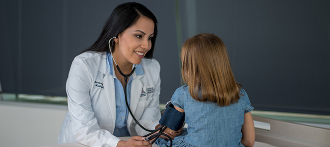 a doctor conducting a blood pressure exam on a child