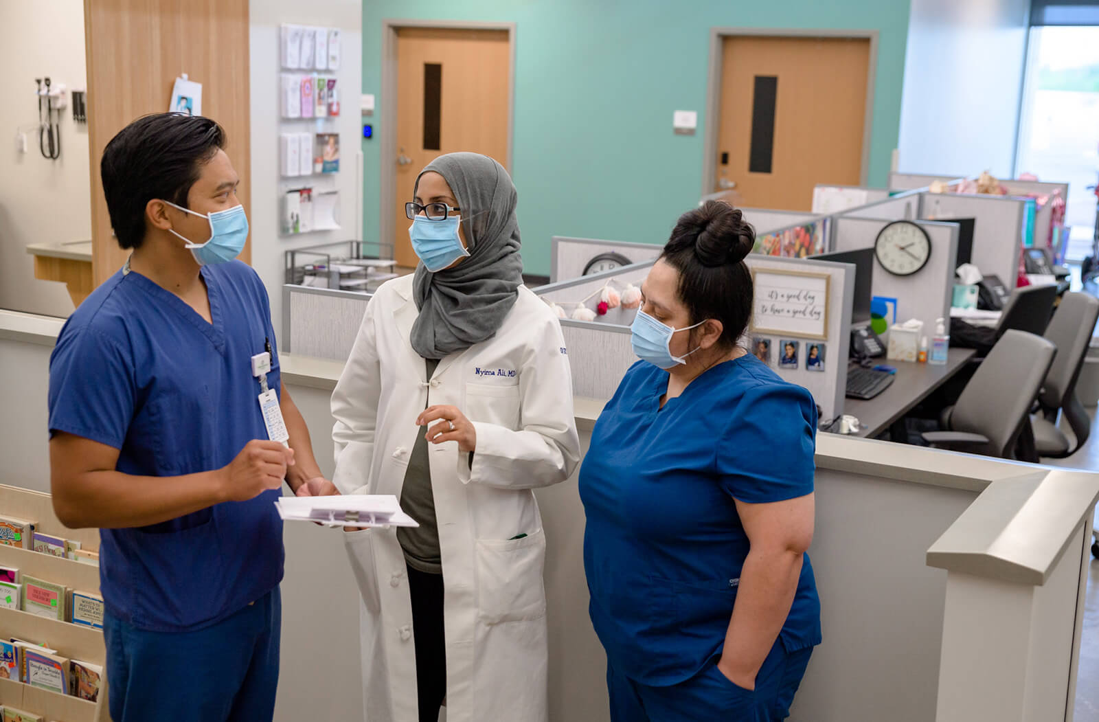 Nyima Ali, MD (Center) Consults with Her Pediatrician Colleague Michael Do, MD, and Angelita Valdez, Medical Assistant, at Valleywise Health