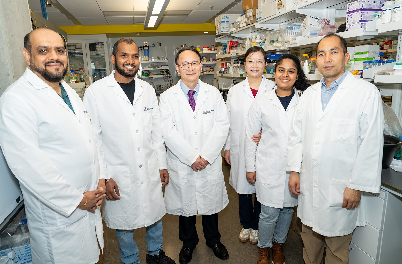 Yanqiao Zhang, MD (center), along with members of his research lab, is investigating how disruptions in liver metabolism may lead to chronic disease.