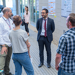 Medical student Dara Farhadi presents his research poster at the conference