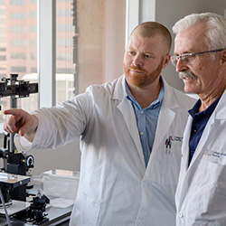 Dr. Blackwood talking with Dr. Glembotski in the TCRC lab