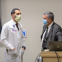 Dr. Basile speaking with Christian Nasr, MD, division chief of Endocrinology, at Banner – University Medical Center Phoenix 