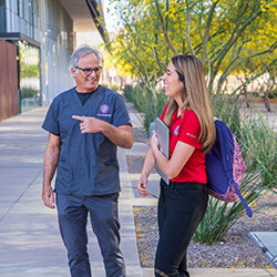 Tapia with Dr. Cartsonis on the college's campus