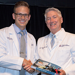 Tanner Ellsworth with Dean Reed at the White Coat Ceremony for the Class of 2021