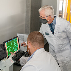 Dr. Glembotski with Erik Blackwood, PhD, Analyzing a Sample