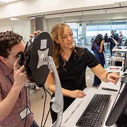 Goforth working with a Summer Scrubs student in the Center for Simulation and Innovation