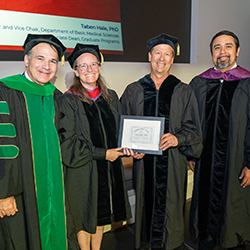 Dean Wondisford, Dr. Hale and Dean Lucio honoring Dr. Kurt Gustin at the event.