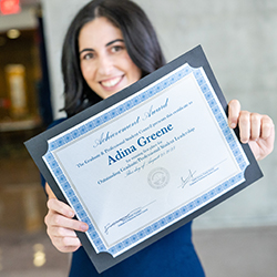 Greene proudly displaying her Outstanding Graduate/Professional Student Achievement Award