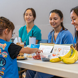 As part of the camp, the Girl Scouts learned about nutrition from the college's medical students