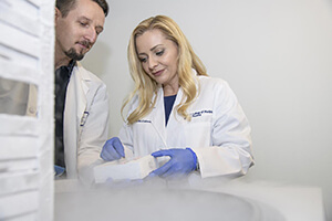 Paweł Łaniewski, PhD, and Melissa Herbst-Kralovetz, PhD, Dip into Their Cell Supply, Which is Stored at −80° Celsius