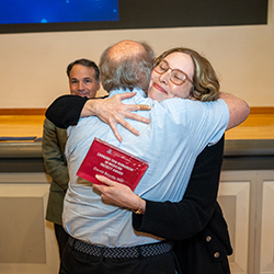 Dr. Beyda — who was honored with the Leonard Tow Award for Humanism for his dedication to delivering compassionate care — hugs Class of 2026 graduate Dr. Emrie Tomaiko-Clark.