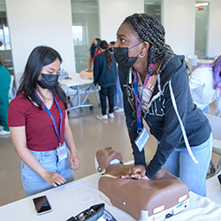 High school students performing CPR chest compressions