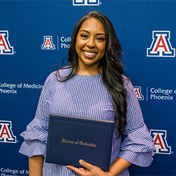 Lena Elias posing with her diploma after presenting the group’s Legacy Project