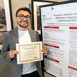 At AED, Adam Zakkar, DO, who finished second in the Fellow - Research/Quality Improvement category, poses with his poster.
