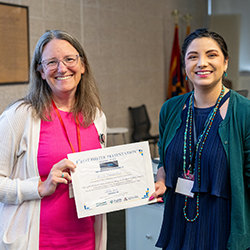 Taben Hale, PhD, with Nicole Jimenez, PhD, a postdoctoral fellow in the lab of Melissa Herbst-Kralovetz, PhD, congratulating her on finishing second in the poster presentations.