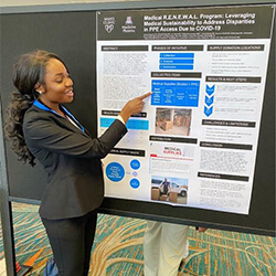 Ohaya with her research poster at the conference