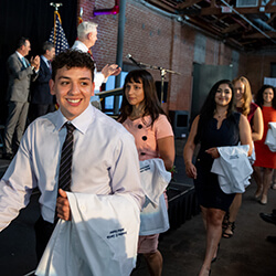 The Class of 2025 Entering Warehouse 215 for the White Coat Ceremony