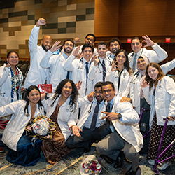 Graduates of the college's Pathway Scholars Program celebrate with Nafis Shamsid-Deen, MD, assistant dean of Admissions and Recruitment, after the ceremony. 