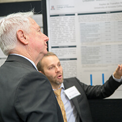 Dean Reed with a Student at the Symposium