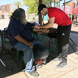 street medicine student with homeless man